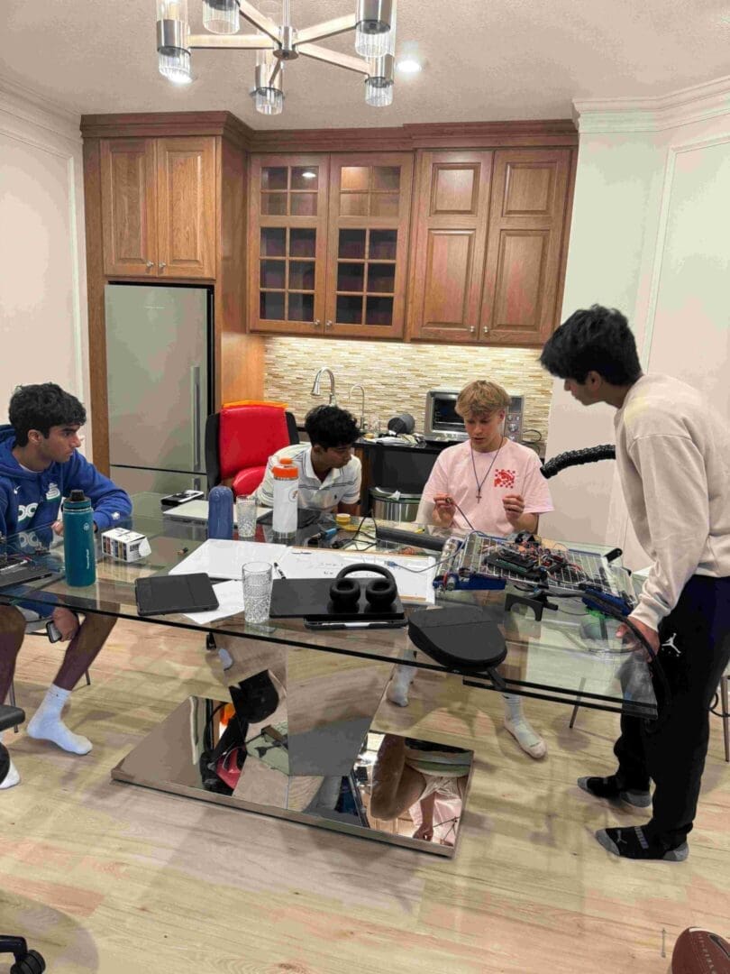 A group of people sitting around a glass table.