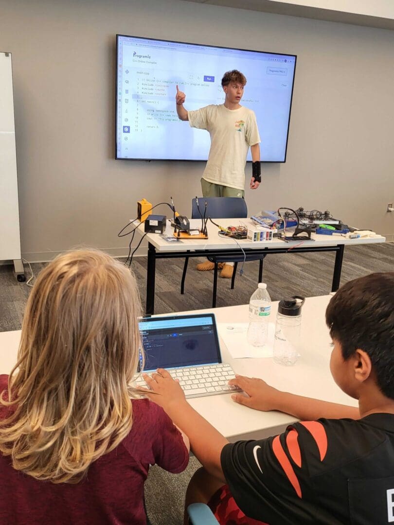 A man is giving a presentation to students